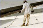 Rubber roof coating being applied to a surface